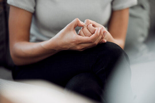 A common sign of anxiety is subconscious skin picking. Cropped shot of an unrecognisable woman sitting alone and feeling anxious while picking the skin on her nails.