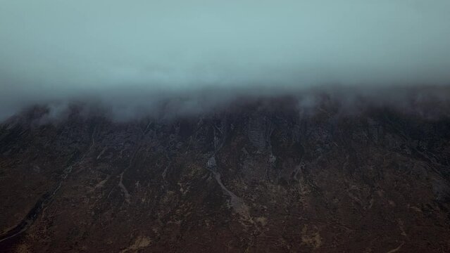 Passing clouds over a mountain peak. Glen Etive in the Highlands. Scotland