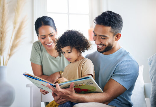 Teaching Her Some New Things. Shot Of A Young Family Reading A Book Together At Home.