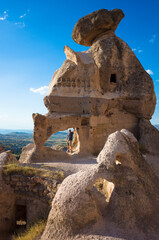 Cappadocia unique rock formation, Tourist standing in the archway of the ruins of an ancient cave...