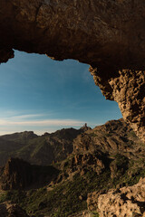 View of Roque Nublo Volcanic Crag Through Arch Rock Formation in Gran Canaria, Spain