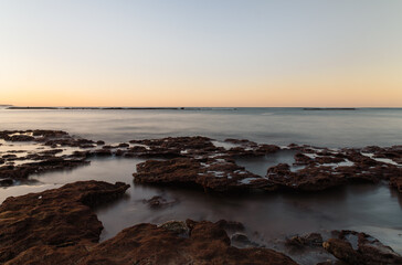Beautiful View of Sunset and Rocks on the Shore of Las Canteras Beach in Las Palmas de Gran Canaria, Spain
