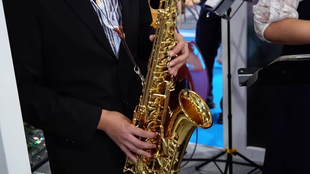 Man's fingers playing on the saxophone. Close up. Playing live jazz concert