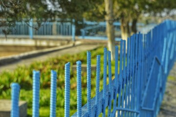 Plain blue rebar fence. Spring. 