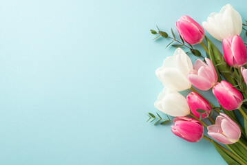 Mother's Day concept. Top view photo of bouquet of white and pink tulips on isolated pastel blue...