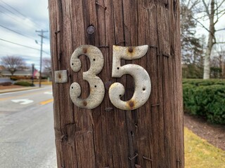 35 number nailed on wooden telephone pole center birthday