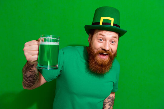 Photo of good moob guy dressed t-shirt cap rising ale beer glass celebrating clover day isolated green color background