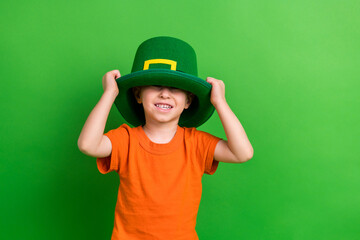 Photo of sweet lovely small kid boy prepare for saint patrick kindergarten occasion isolated green...