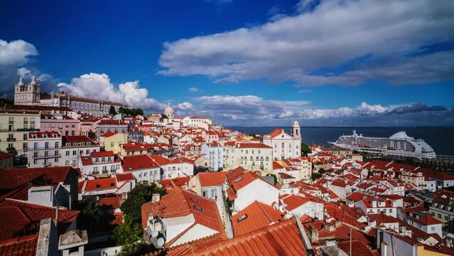 Timelapse of Lisbon famous view from Miradouro de Santa Luzia tourist viewpoint over Alfama old city district, cruise liner and moving clouds. Lisbon, Portugal