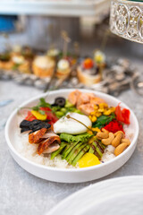 salad bowl with different ingredients on a white plate