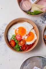 breakfast fried eggs with vegetables. breakfast in a craft plate