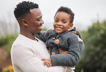 They love spending quality time together outdoors. Portrait of an adorable little boy being carried...