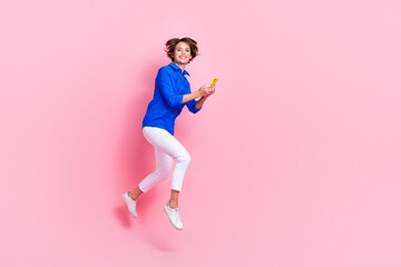 Fototapeta na wymiar Full length photo of satisfied optimistic business worker hold smartphone chatting with her recruiter approve job isolated on pink color background