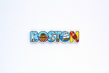 Colourful PVC souvenir fridge magnet of Boston, USA on white background. Travel memory concept. Gift typical product for tourists from foreign trip. Home decoration. Top view, flat lay, close up