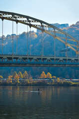 Man paddle boarding on the Monongahela River in Pittsburgh, PA