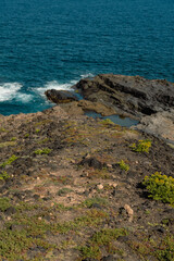 View of rocky coastine near Salinas del Bufadero salt lake near Arucas, in the northern coast of Gran Canaria, Spain