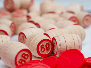 Board game bingo. Wooden barrels with lotto numbers, playing cards for the game. Close-up.