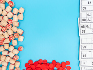 Board game bingo. Wooden barrels with lotto numbers, playing cards for the game. Close-up.