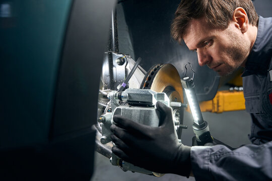 Worker doing inspection of the brake system