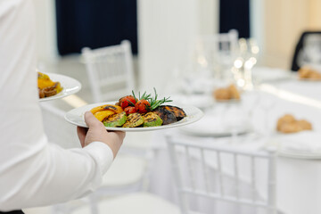 waiter serving food in restaurant