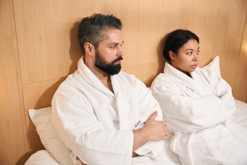 Unhappy young couple in their hotel room