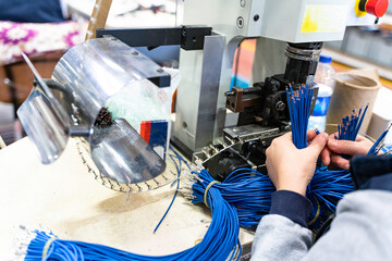 Female industrial worker working with manufacturing equipment in a factory