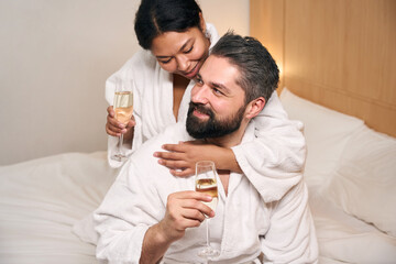 Cheerful couple drinking together to their anniversary