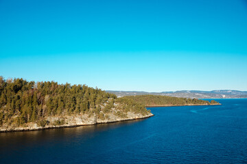 Small island next to a fjord in Norway. Small white houses on a small island in the North Sea. Beautiful life in nature, in Scandinavia	