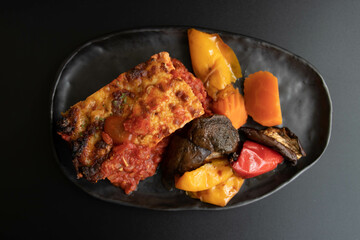 Italian Traditional food, Lasagna, on black background