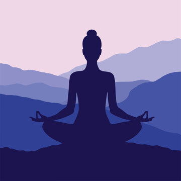 Silhouette of a woman meditating in the mountains in twilight.	
