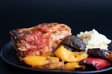 Italian Traditional food, Lasagna, on black background