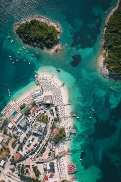 Aerial view of people with parasols on Bora Bora Beach, Ksamil, Albania.