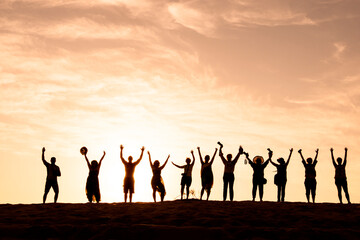 Silhouette of happy business group team over sunset sky. Success and teamwork concept in company with hands up over beautiful sunset sky for business success and teamwork concept in company