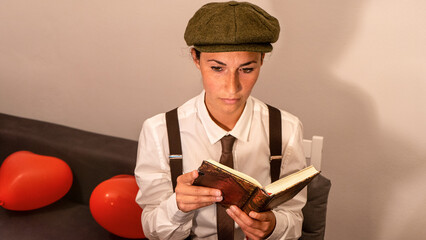 portrait of a woman acting a man holding a book lost in his thoughts