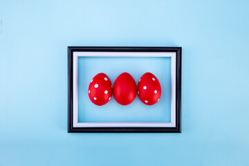 Easter red eggs in a frame. Flat lay, copy space.