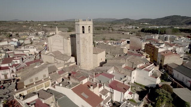 Orbital Drone 4K flight towards the Arciprestal Church of Sant Mateu and its octagonal-shaped Templar bell tower in Spain