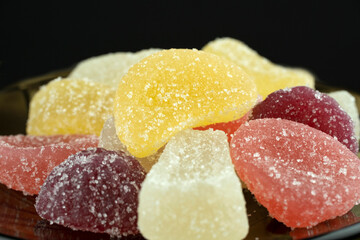 Multi-colored, marmalade candies, close-up, isolated on a black background.