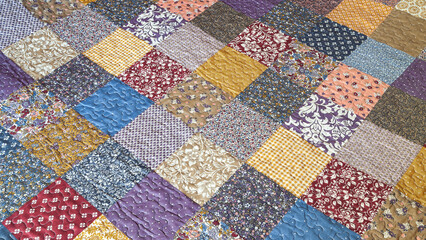 Print in patchwork style. Quilted quilt with patchwork print. Geometrical pattern. Selective focus