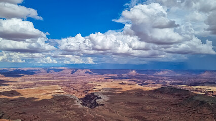 Panoramic aerial view on Colorado River canyon seen from Buck Canyon Overlook near Moab, Island in the Sky District, Canyonlands National Park, San Juan County, Utah, USA. Clouds and sky in summer