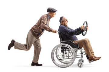 Full length profile shot of an elderly man pushing a mature man in a wheelchair holding a steering wheel