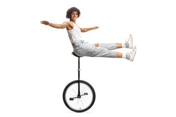 African american acrobat sitting on a monocycle