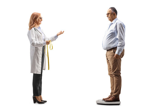 Full Length Profile Shot Of A Female Doctor Talking To A Mature Man Standing On A Weight Scale