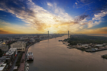 aerial shot of a gorgeous sunset over the Savannah River with Talmadge Memorial Bridge, hotels,...