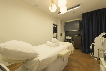 Individual cabins in the massage room with beds for the application of treatments with clean towels