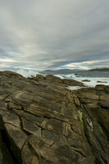 Fototapeta premium A stormy day on the coast with an agitated sea reaches the cliffs with large waves