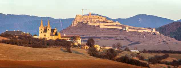 Panoramic view to Spis Castle and Saint Martin’s Cathedral at sunset.