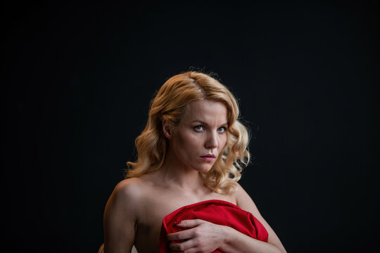 Portrait of candid authentic elegant sexy model blonde girl posing in red pantsuit bare back no bra