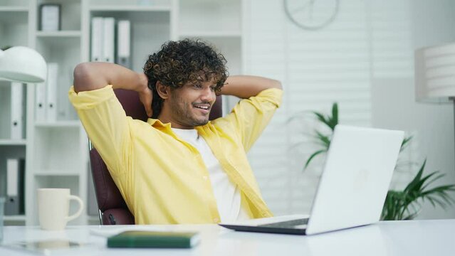 Employee job done Satisfied office worker freelancer coder leaning back businessman relaxing after hard working day finished project on computer stretching at workplace happy closed eyes taking pause