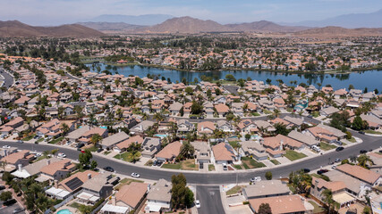 Aerial view of sprawling single family home neighborhood and lake of Menifee, California, USA.