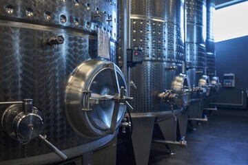 Industrial environment . huge metal tanks used for reductive wine making in vine cellar of modern winery. - obrazy, fototapety, plakaty